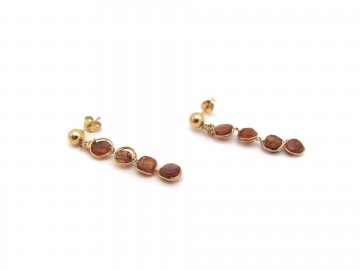 Gouden oorstekers zonnesteen